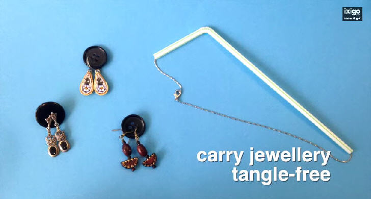 Place earrings in buttons and necklace in straw to carry jewellery tangle-free